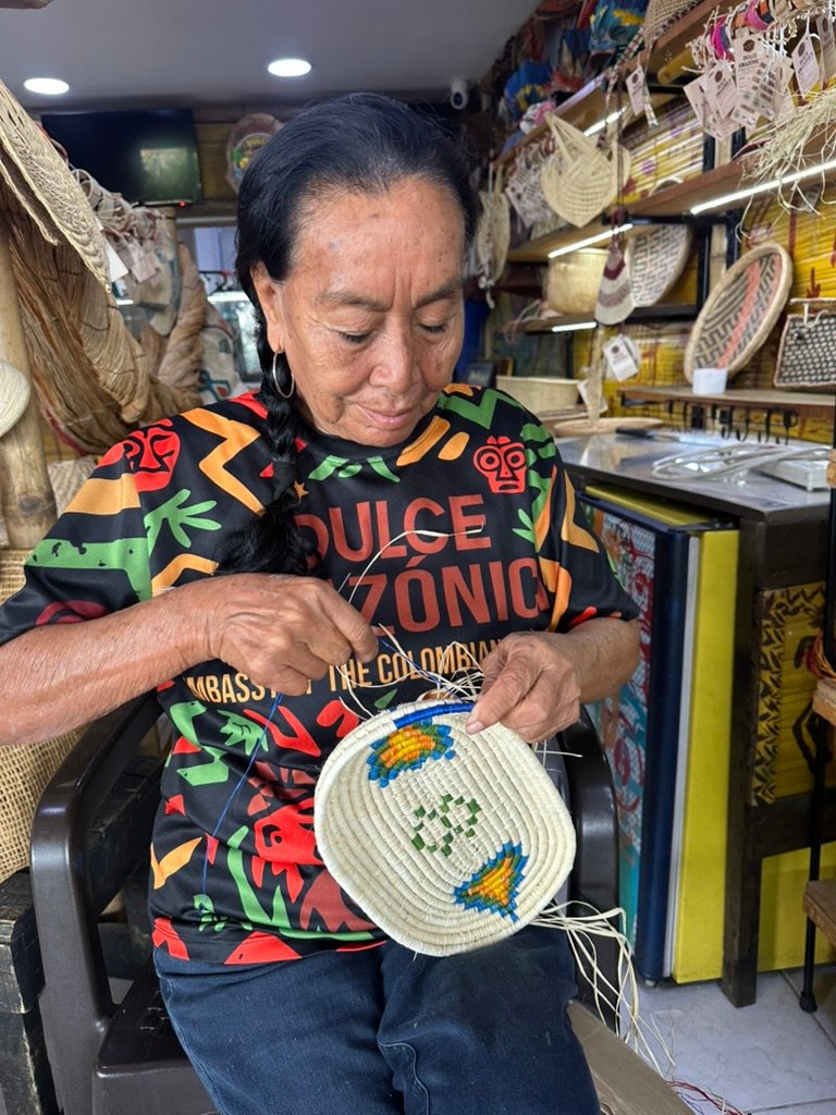 Indigenous ambassador weaving at Dulce Amazonica